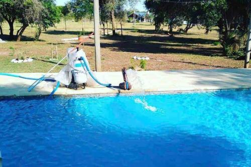 a water slide in the middle of a swimming pool at Pura Vida in Yapeyú