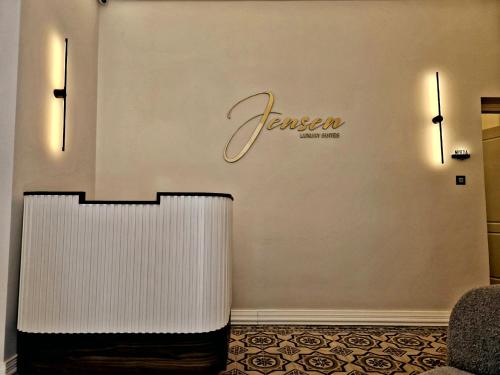 a hotel lobby with a sign on the wall at Jensen Luxury Suites in Rhodes Town