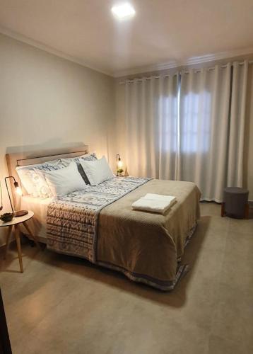 Postel nebo postele na pokoji v ubytování Casa Romão 2 Pertinho de Vinícola e Centro