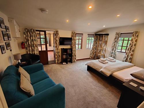 a living room with a bed and a couch at The Garden Lodge in Llynclys
