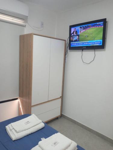 a hospital room with a bed and a tv at Naturaleza Termal in Chajarí