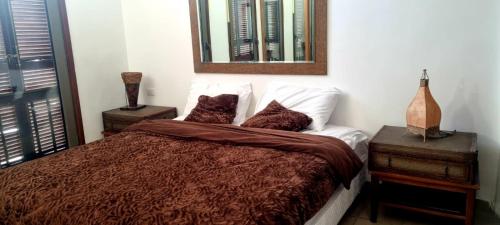 a bedroom with a bed and a mirror on the wall at Flat One room apartment in talabay aqaba in Al Burj