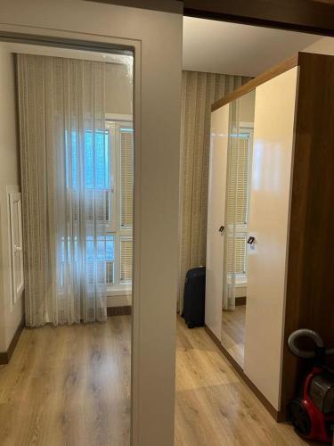 um quarto com um espelho e um quarto com uma janela em Tual bahçekent 1+1 studio em Basaksehir