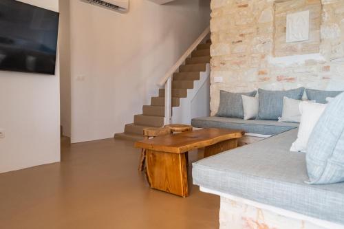 a living room with a couch and a table at Aegean Feelings in Piso Livadi