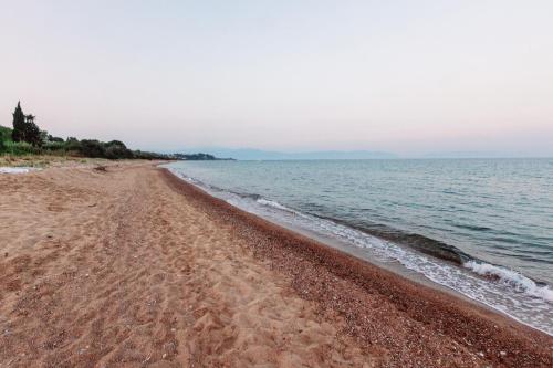 a sandy beach with the ocean in the background at Seaheaven houses A2 in Koroni