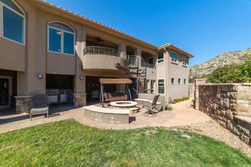a house with a patio with a fire pit in the yard at Majestic Mountain Escape-hike trails from backyard in Albuquerque