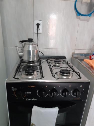 a stove with a tea kettle on top of it at Pousada do Joaquimxdarc in Natal