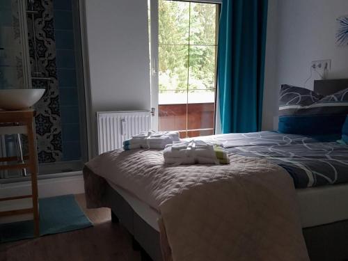 a bedroom with a bed with towels on it at Apartment in Dorfzentrum near Lake in Feld am See