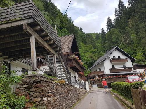 a man walking down a street next to a building at Apartment in Dorfzentrum near Lake in Feld am See