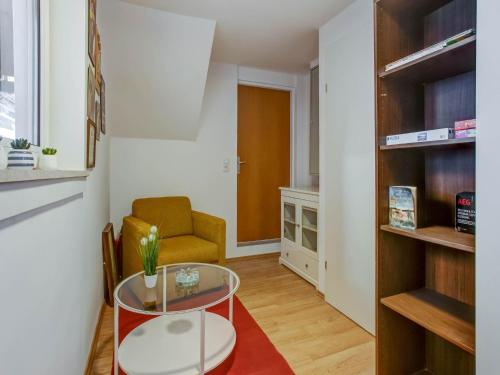 a living room with a glass table and a chair at Apartment Feld am See near Feldsee Lake in Feld am See