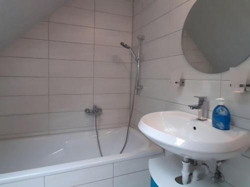 a white bathroom with a sink and a shower at Property in Burgk in Burgk