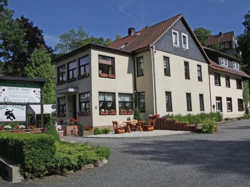 a large white building with a table in front of it at Charmantes Dachgeschoss-Refugium, Harz in Wildemann