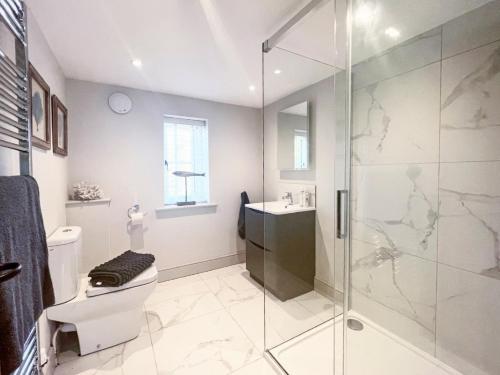 a bathroom with a shower and a toilet and a sink at The Old Stables 2 - Uk35616 in West Winterslow