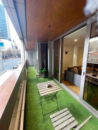 a balcony with two benches and a couch on a building at Nest Apartments on Rose Lane in Melbourne