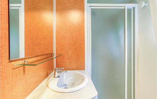 a bathroom with a sink and a mirror at Lovely stacaravan In Conques-en-rouergues With Outdoor Swimming Pool in Conques-en-Rouergue