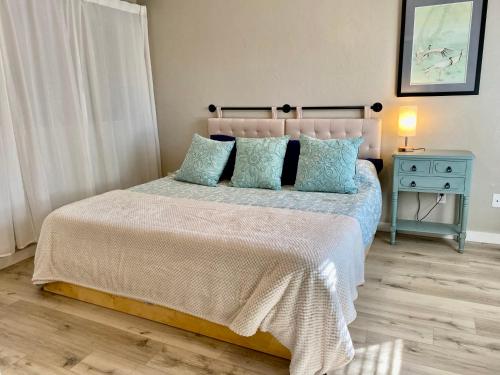 a bedroom with a large bed with blue pillows at Artist's Tower Townhome Just Renovated w Loft in Gainesville