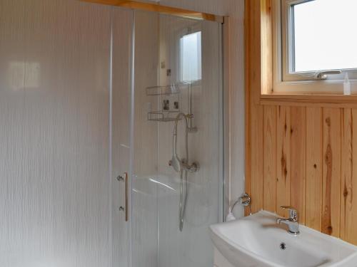 a bathroom with a shower and a sink at Shepherds Hut 3 At Laddingford - Uk32532 in Yalding