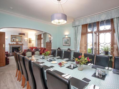 a conference room with a long table and chairs at Ranscombe House in Brixham