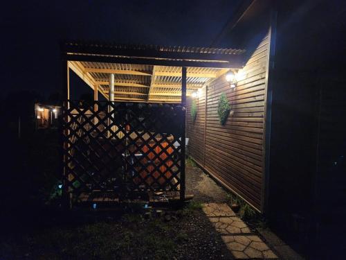 a gate with a wooden fence at night at Cabañas Entre copihues in Osorno