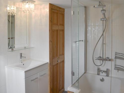 a bathroom with a shower and a sink and a tub at Duke Street in Lostwithiel