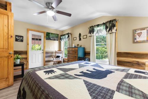 a bedroom with a bed and a ceiling fan at Bears Tree 2 in Sevierville