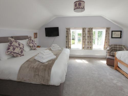 a bedroom with a large bed with towels on it at Netherwood in Bakewell