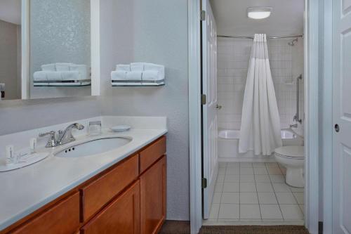 a bathroom with a sink and a toilet at Residence Inn by Marriott Fort Lauderdale Weston in Weston
