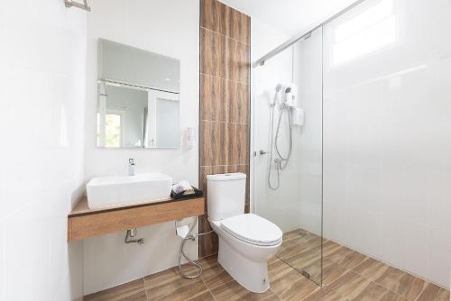 a bathroom with a white toilet and a sink at Picha Ville Resort in Watthana Nakhon