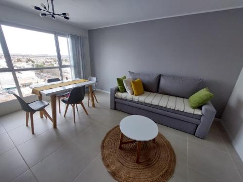 a living room with a couch and a table at Calidez, confort y relax. in Trelew