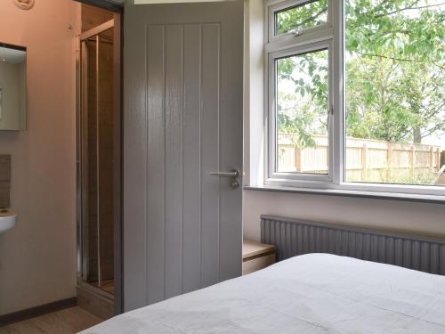 a bedroom with a white bed and a window at 185 Golf Road in Mablethorpe