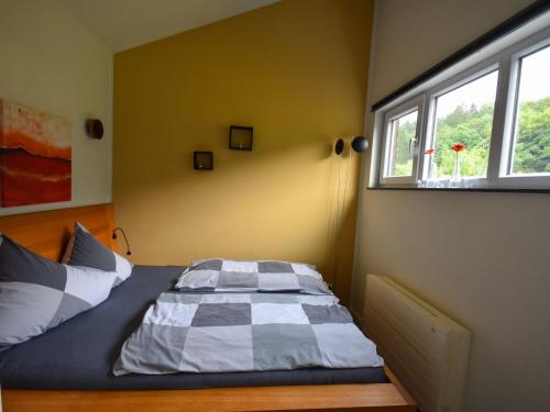 a bed in a room with a window at Holiday Home in Forest with Terrace & BBQ in Berlingen