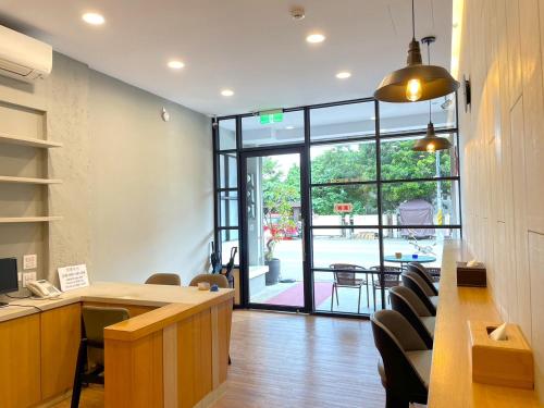 an office with a desk and chairs and a large window at 35.5 Inn in Kenting