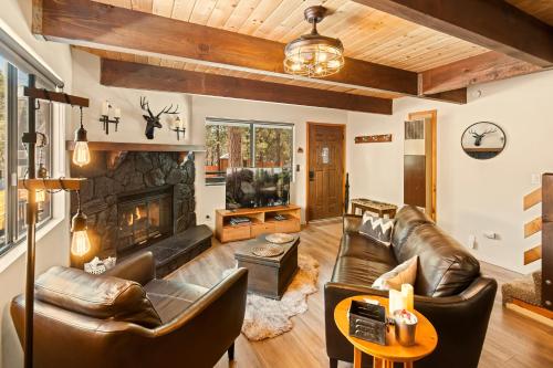 a living room with leather furniture and a fireplace at Sugar in the Raw Cabin w AC - Hot Tub in Sugarloaf