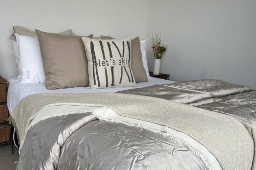 a bed with pillows and a comforter on it at Views on Florence in Queenstown