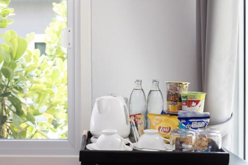 a shelf with bottles of milk and other food at Picha Ville Resort in Watthana Nakhon