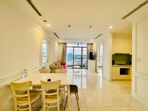 a kitchen and living room with a table and chairs at DongDong Luxury Apartment in Vinhomes Central Park in Ho Chi Minh City
