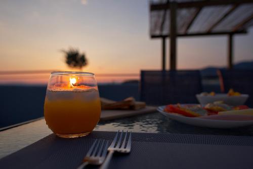 a candle sitting on a table with a plate of food at Kiriakos Apartment in Kalamata