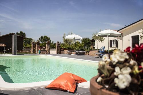 a swimming pool with an orange object in front of a house at Residence Terra Dei Santi Country House in Spello
