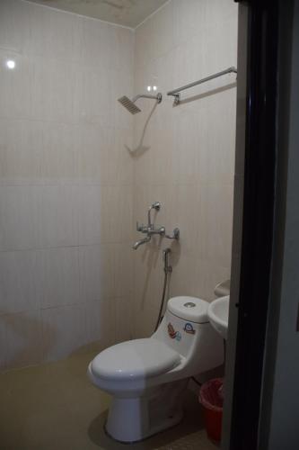 a bathroom with a toilet and a sink at Hotel Garangja in Bandīpur