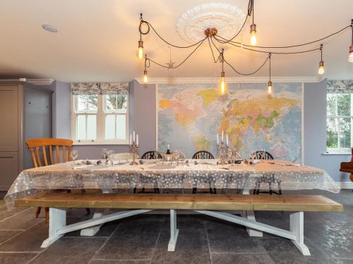 a dining room with a large table with wine glasses at Vallis Oak Villa in Frome