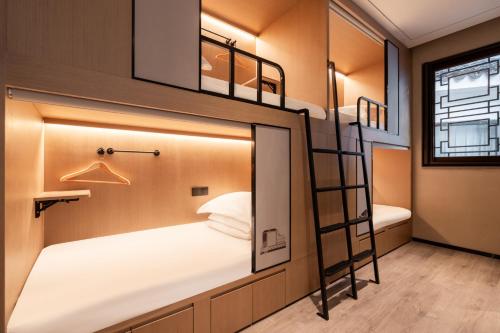 a bedroom with bunk beds in a tiny house at Zunjing Boutique Hotel Nanjing Confucius Temple in Nanjing