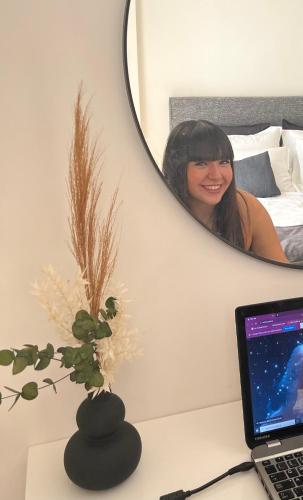 a desk with a laptop computer and a mirror at KK Athens Fine Stay-Steps to Metro-Modern & Cozy Apartments in Athens