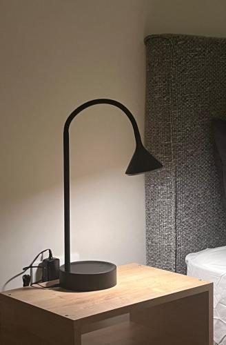 a black lamp sitting on a desk next to a bed at KK Athens Fine Stay-Steps to Metro-Modern & Cozy Apartments in Athens