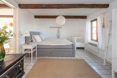 a bedroom with a bed and a table in a room at Swedish Farmhouse near Malmö and Copenhagen in Trelleborg