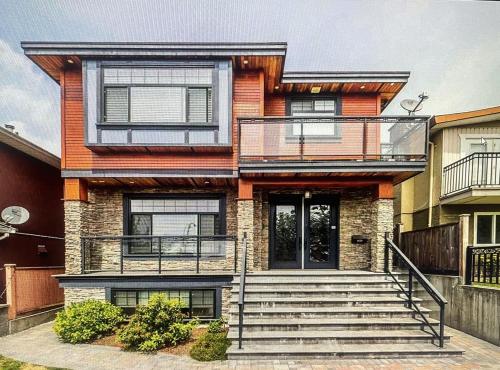 a house with a staircase in front of it at Jennifer's House in Vancouver