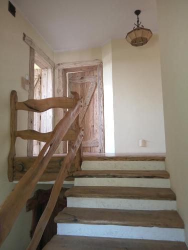 a staircase in a room with a wooden door at Chatka skrzatka in Kruki