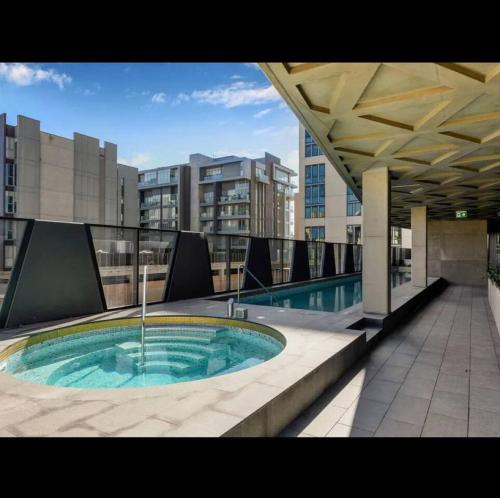 a hot tub on the roof of a building at Sky Apartment - Realm Adelaide in Adelaide