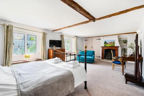 a bedroom with a bed and a desk and a couch at Walnut Tree House in Rustington