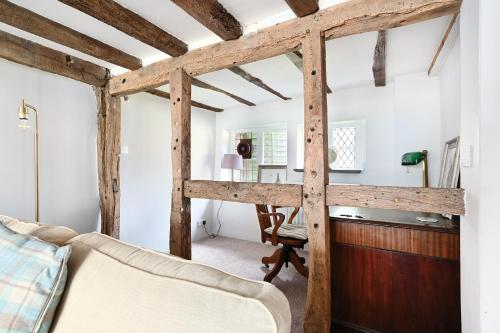 a bedroom with a loft bed and a desk at Walnut Tree House in Rustington