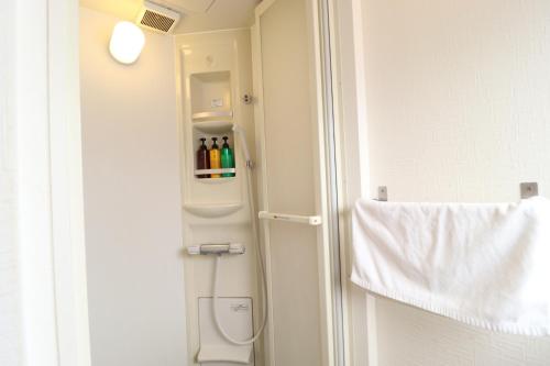 a bathroom with a toilet and a towel at Ozawa Building in Osaka